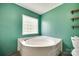 Corner bathtub with block window providing natural light in a well lit room at 284 Cedar Grove Rd, Clover, SC 29710