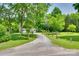 A long driveway leads to this home with mature trees and grass at 284 Cedar Grove Rd, Clover, SC 29710
