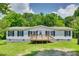 Charming one-story home featuring a front porch, well-manicured lawn, and fresh white siding at 284 Cedar Grove Rd, Clover, SC 29710