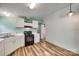 Functional kitchen featuring white cabinets, laminate countertops, and black oven range with adjacent dining area at 284 Cedar Grove Rd, Clover, SC 29710