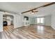 The living room boasts stylish wood flooring, a ceiling fan, and a seamless flow into the adjacent kitchen at 284 Cedar Grove Rd, Clover, SC 29710