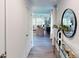 Bright entryway featuring wood floors, a round mirror, and view into the spacious and well-lit living room at 3090 Ora Smith Rd, Lincolnton, NC 28092