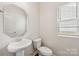 Bathroom with a pedestal sink, toilet, and decorative mirror at 3107 Riker St, Clover, SC 29710