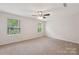 Spacious bedroom featuring a ceiling fan, carpet flooring, and large windows for ample natural light at 3107 Riker St, Clover, SC 29710