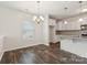 Cozy dining area with hardwood floors, chandelier, and a view of the bright, modern kitchen at 3107 Riker St, Clover, SC 29710
