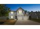Beautiful two-story home featuring a two-car garage, set against a clear evening sky at 3107 Riker St, Clover, SC 29710