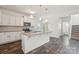 Bright kitchen with white cabinets, granite island, stainless appliances, and hardwood floors at 3107 Riker St, Clover, SC 29710