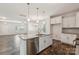 Modern kitchen island featuring stainless steel dishwasher, granite countertops, and stylish pendant lighting at 3107 Riker St, Clover, SC 29710