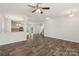 Open-concept living area with hardwood floors leading to the kitchen and staircase at 3107 Riker St, Clover, SC 29710