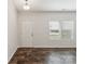 Bright living room featuring hardwood floors, a white door, and large window for ample natural light at 3107 Riker St, Clover, SC 29710