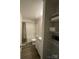 Well-lit bathroom with a shower-tub combo, vanity, and storage shelves at 323 J C Dellinger Rd, Cherryville, NC 28021
