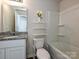 Bright bathroom featuring granite counters, a white vanity and a shower-tub combination at 323 J C Dellinger Rd, Cherryville, NC 28021