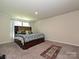 Bedroom features a beautiful bed, neutral carpeting, and lots of space for furniture at 323 J C Dellinger Rd, Cherryville, NC 28021