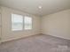 A carpeted empty bedroom space featuring natural light and plenty of room for personalization at 323 J C Dellinger Rd, Cherryville, NC 28021