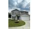 Two-story home featuring gray siding, a two-car garage, and a well-manicured lawn at 323 J C Dellinger Rd, Cherryville, NC 28021