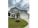 Two-story home featuring gray siding, a two-car garage, and a well-manicured lawn at 323 J C Dellinger Rd, Cherryville, NC 28021