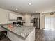 Modern kitchen with granite countertops, stainless steel appliances, and hardwood floors at 323 J C Dellinger Rd, Cherryville, NC 28021