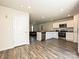 Open kitchen and living room with stainless steel appliances, white cabinets, and granite countertops at 323 J C Dellinger Rd, Cherryville, NC 28021