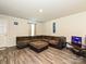 Spacious living room with hardwood floors, a large sectional couch, and access to a side entry door at 323 J C Dellinger Rd, Cherryville, NC 28021