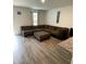 Open concept living room features wood flooring and a large brown sectional sofa at 323 J C Dellinger Rd, Cherryville, NC 28021