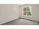 Well-lit bedroom featuring a window and neutral carpet and paint at 3429 Lazy Day Ln, Charlotte, NC 28269