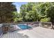 A deck with a view of the pool and lush landscaping at 3429 Lazy Day Ln, Charlotte, NC 28269