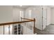 This is a hallway with carpeted steps and a wood banister that leads to the rooms upstairs at 3429 Lazy Day Ln, Charlotte, NC 28269