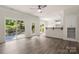 Sun-filled living room with hardwood floors, deck access, and a breakfast bar at 3429 Lazy Day Ln, Charlotte, NC 28269