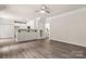 Open-concept living room with hardwood floors and breakfast bar at 3429 Lazy Day Ln, Charlotte, NC 28269