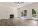 Bright living room featuring a fireplace, ceiling fan, and sliding glass door to deck at 3429 Lazy Day Ln, Charlotte, NC 28269