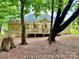 Backyard view of a brick home with a spacious wooden deck at 35 Wittenburg Springs Dr, Taylorsville, NC 28681