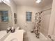 Neat bathroom featuring white tiled floor and a shower and bathtub combination at 35 Wittenburg Springs Dr, Taylorsville, NC 28681