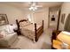 Bedroom featuring a patterned bed, a ceiling fan, and an adjacent sitting area at 35 Wittenburg Springs Dr, Taylorsville, NC 28681