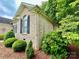 Side view of brick home with well-maintained landscaping at 35 Wittenburg Springs Dr, Taylorsville, NC 28681