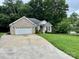 Charming brick home with a well-manicured lawn and a two-car garage at 35 Wittenburg Springs Dr, Taylorsville, NC 28681