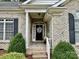 Inviting front entrance with a decorative wreath and a comfortable seating area at 35 Wittenburg Springs Dr, Taylorsville, NC 28681