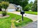 Charming brick home featuring a well-manicured lawn, mature trees, and a convenient two-car garage at 35 Wittenburg Springs Dr, Taylorsville, NC 28681