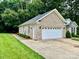 Spacious two-car garage with a side door, offering ample parking and storage at 35 Wittenburg Springs Dr, Taylorsville, NC 28681