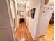 Hallway with hardwood floors and artwork leading to the laundry room and other areas of the home at 35 Wittenburg Springs Dr, Taylorsville, NC 28681