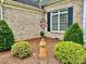 Landscaped front of brick home with nice shrubbery, statue, and well-maintained yard at 35 Wittenburg Springs Dr, Taylorsville, NC 28681