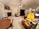 Spacious living room with a fireplace, ceiling fan, floral sofas, and a dining table at 35 Wittenburg Springs Dr, Taylorsville, NC 28681