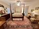 Comfortable bedroom featuring a four poster bed, area rug, and an ensuite bathroom at 35 Wittenburg Springs Dr, Taylorsville, NC 28681