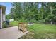 A well-maintained backyard lawn, a planter and a seating area with four chairs at 3951 Tersk Dr, Midland, NC 28107