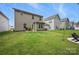 Backyard view with a well-maintained lawn and the exterior of the house at 3951 Tersk Dr, Midland, NC 28107