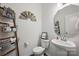 Cozy half bath with pedestal sink and decorative ladder with basket at 3951 Tersk Dr, Midland, NC 28107