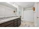 Bathroom features double sink with granite counters and tiled floors at 3951 Tersk Dr, Midland, NC 28107