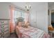 Charming bedroom with pink accents and a decorative chandelier at 3951 Tersk Dr, Midland, NC 28107
