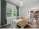 Bright dining room features wood table with seating for six adjacent to kitchen at 3951 Tersk Dr, Midland, NC 28107