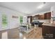 Bright kitchen with stainless steel appliances, dark wood cabinets, and dining area at 3951 Tersk Dr, Midland, NC 28107