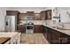 Modern kitchen with stainless steel appliances, granite countertops, and dark wood cabinetry at 3951 Tersk Dr, Midland, NC 28107